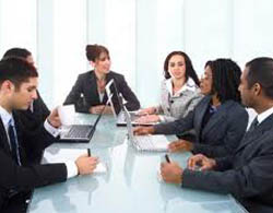 Image of people sitting around a boardroom table